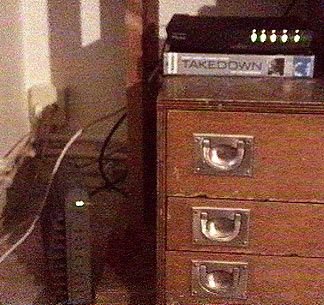 at the bottom-left: LANcity cablemodem, and at the top-right: Alcatel Speed Touch Home ADSL on top of a VHS-box